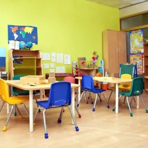 A classroom with tables and chairs in it