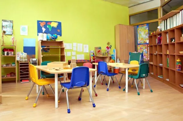 A classroom with tables and chairs in it