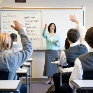 A woman standing in front of a class room