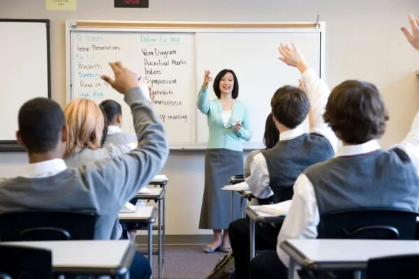 A woman standing in front of a class room