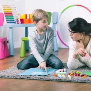 A woman and boy sitting on the floor