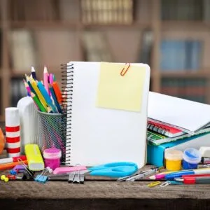 A desk with many school supplies on it